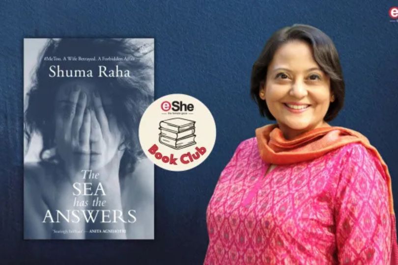 Shuma Raha posing beside the cover of her novel The Sea Has the Answers, which explores contemporary India's social realities.